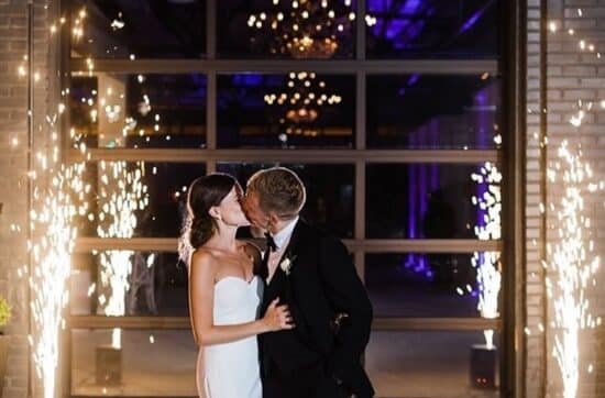 wedding couple exits the abbott with cold sparks on either side from icon events group